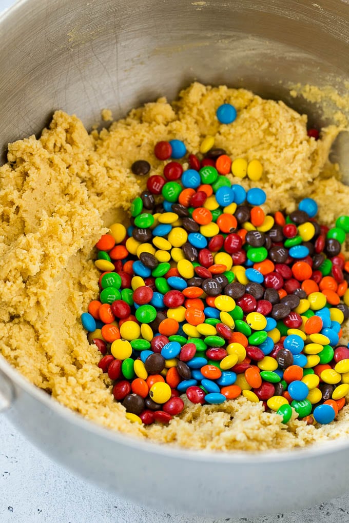 Oreo Stuffed Cookies Recipe | M&M's cookies | Stuffed Cookies #cookies #chocolate #oreos #dessert #baking #bajap Cookie dough in a mixing bowl with miniature M&M's in it.