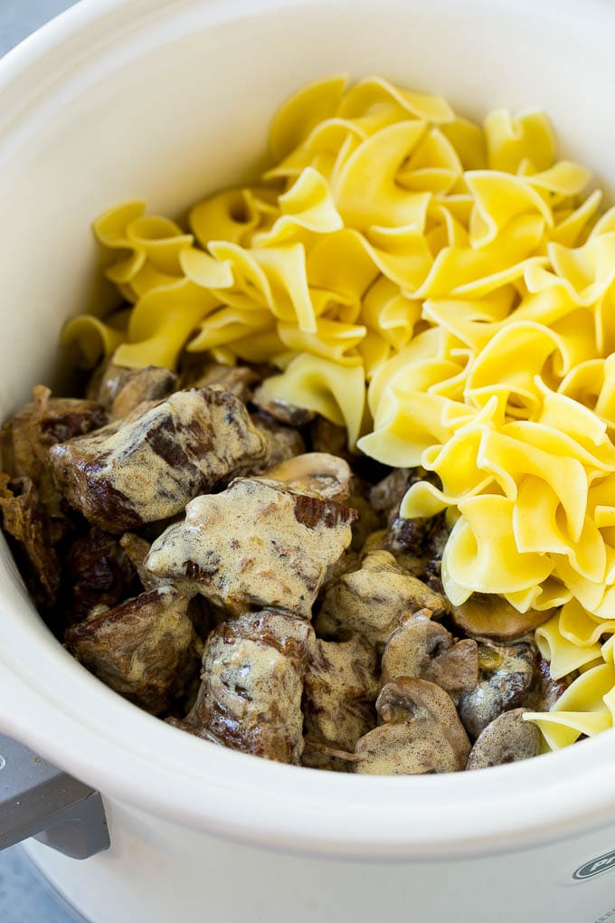 Slow Cooker Beef Stroganoff Recipe | Crock Pot Beef Stroganoff | Beef Recipe #slowcooker #crockpot #beef #mushrooms #pasta #dinner #bajap Beef in a creamy sauce and egg noodles in a slow cooker.