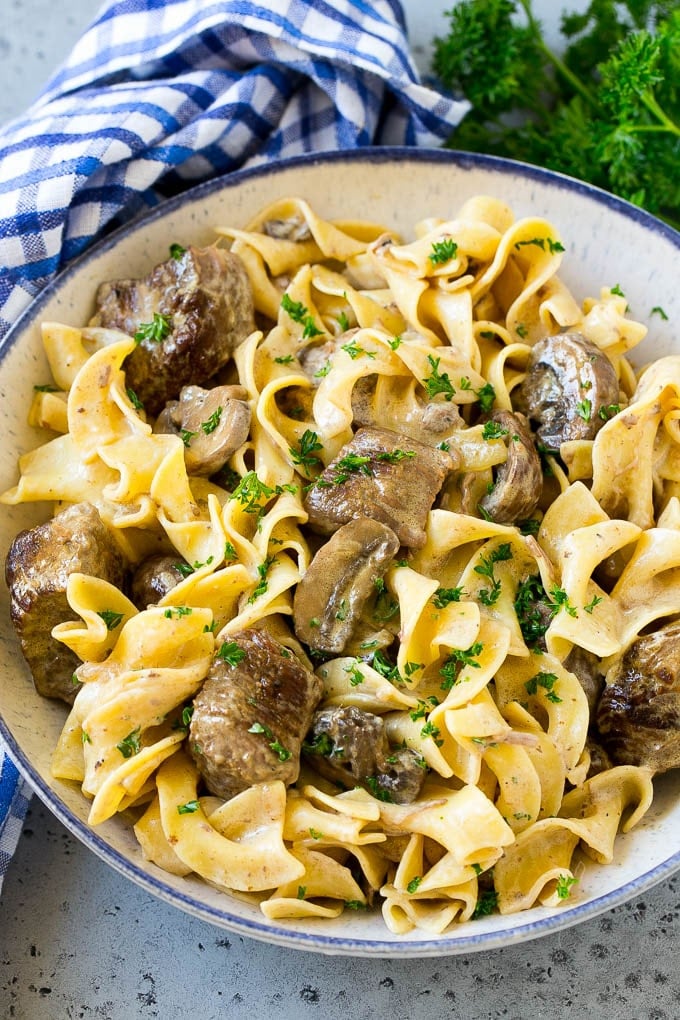 Slow Cooker Beef Stroganoff Recipe | Crock Pot Beef Stroganoff | Beef Recipe #slowcooker #crockpot #beef #mushrooms #pasta #dinner #bajap A bowl of slow cooker beef stroganoff with egg noodles.