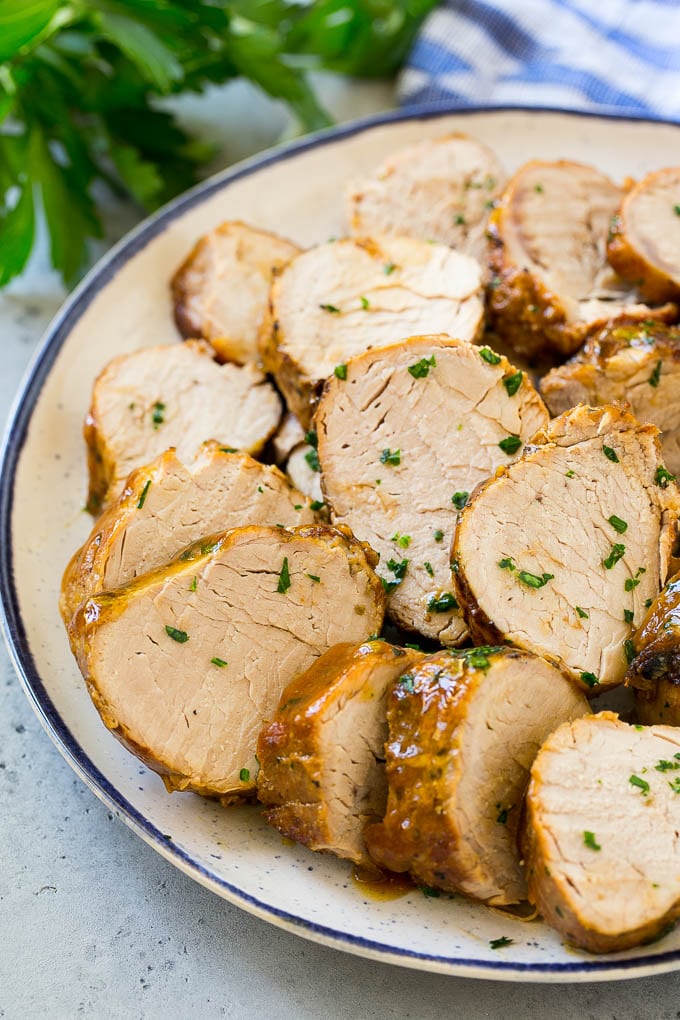 Slow Cooker Pork Tenderloin Recipe | Crock Pot Pork Tenderloin | Easy Pork Tenderloin #slowcooker #crockpot #pork #dinner #bajap Sliced slow cooker pork tenderloin on a plate.