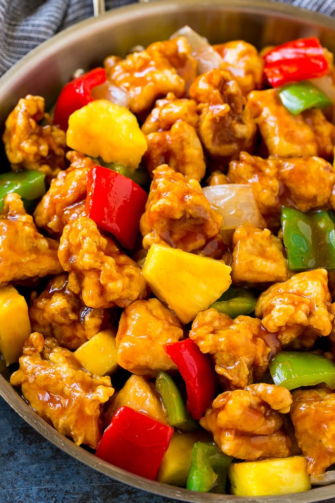 Sweet and Sour Chicken Recipe | Chinese Food Copycat Recipe | Chicken with Pineapple #chicken #chinesefood #pineapple #stirfry #takeout #dinner #bajap A frying pan of sweet and sour chicken with crispy chicken, pineapple, bell peppers and onions.