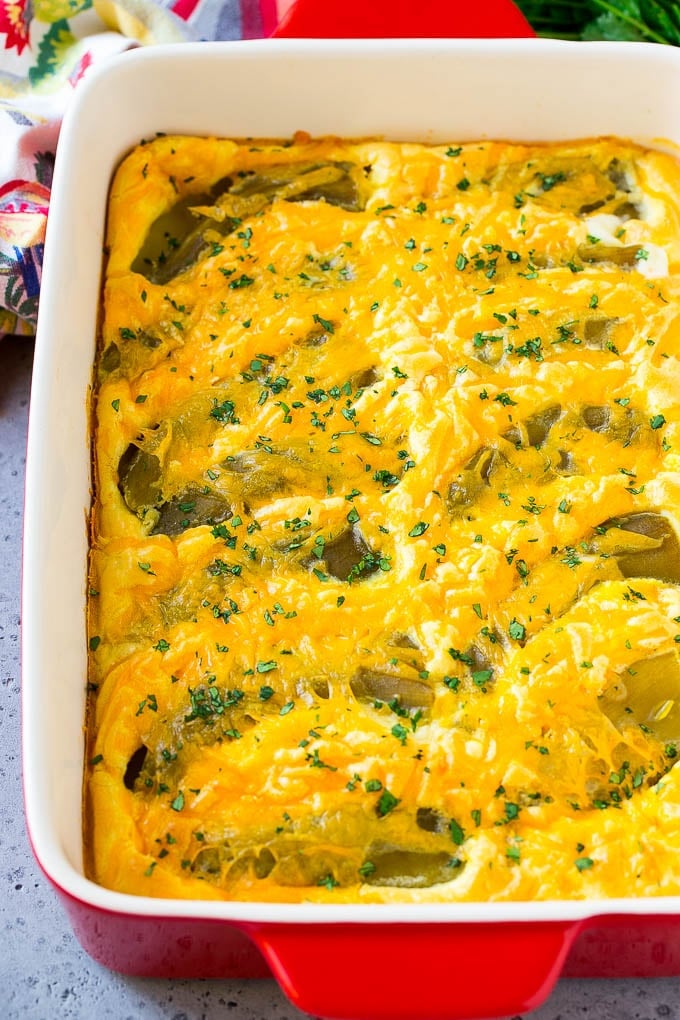 Chile Relleno Casserole Recipe | Baked Chile Rellenos | Mexican Casserole #casserole #chiles #mexican #cheese #dinner #bajap A dish of chile relleno casserole topped with cheddar cheese and chopped cilantro.