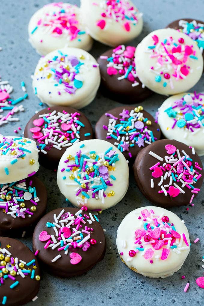 Chocolate Covered Oreos Recipe | Oreo Cookies | Chocolate Dipped Oreos #oreo #cookies #chocolate #sprinkles #dessert #bajap Chocolate covered Oreos decorated with pink and purple sprinkles.