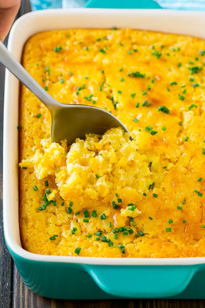 Corn Pudding Recipe | Corn Casserole | Corn Side Dish #corn #pudding #casserole #sidedish #thanksgiving #dinner #bajap A pan of corn pudding with a serving spoon in it.