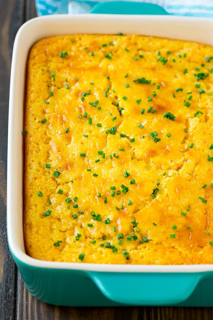 Corn Pudding Recipe | Corn Casserole | Corn Side Dish #corn #pudding #casserole #sidedish #thanksgiving #dinner #bajap A casserole dish of corn pudding topped with chives.