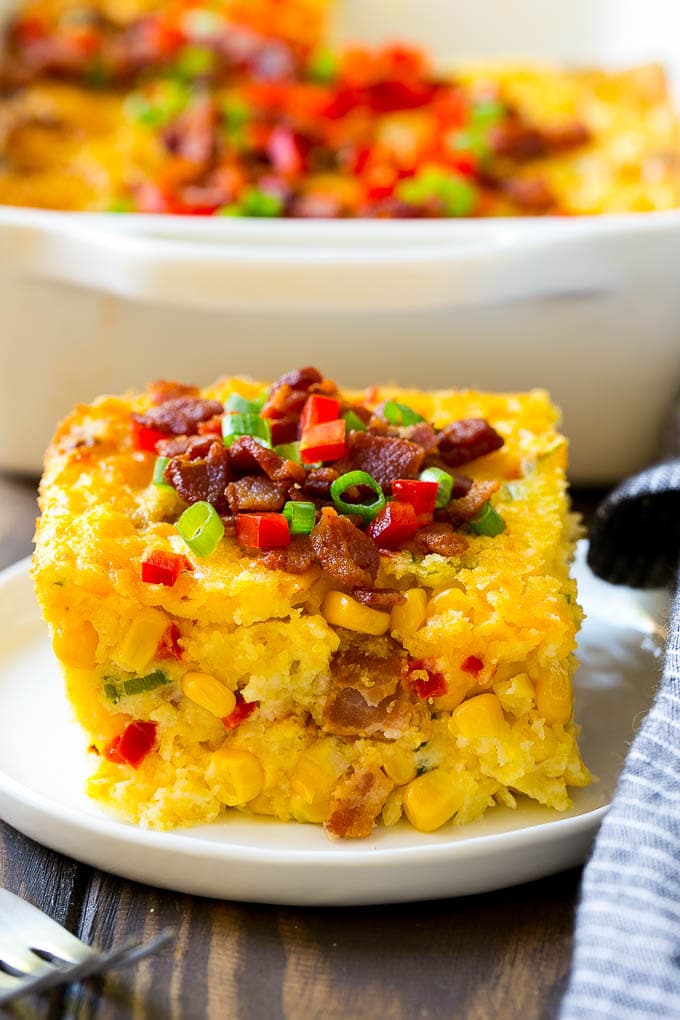 Loaded Corn Casserole Recipe | Easy Corn Casserole | Bacon Corn Casserole | Corn Pudding #corn #casserole #bacon #cheese #sidedish #thanksgiving #dinner #bajap A serving of corn casserole filled with bacon, cheese and peppers.
