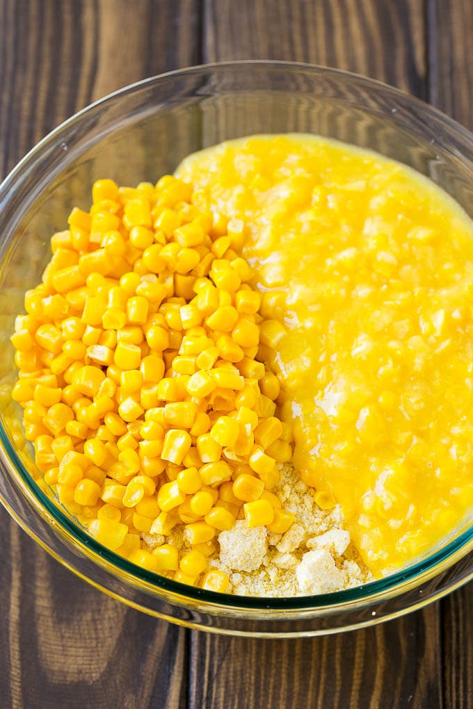 Loaded Corn Casserole Recipe | Easy Corn Casserole | Bacon Corn Casserole | Corn Pudding #corn #casserole #bacon #cheese #sidedish #thanksgiving #dinner #bajap Cornbread mix, corn and creamed corn in a mixing bowl.