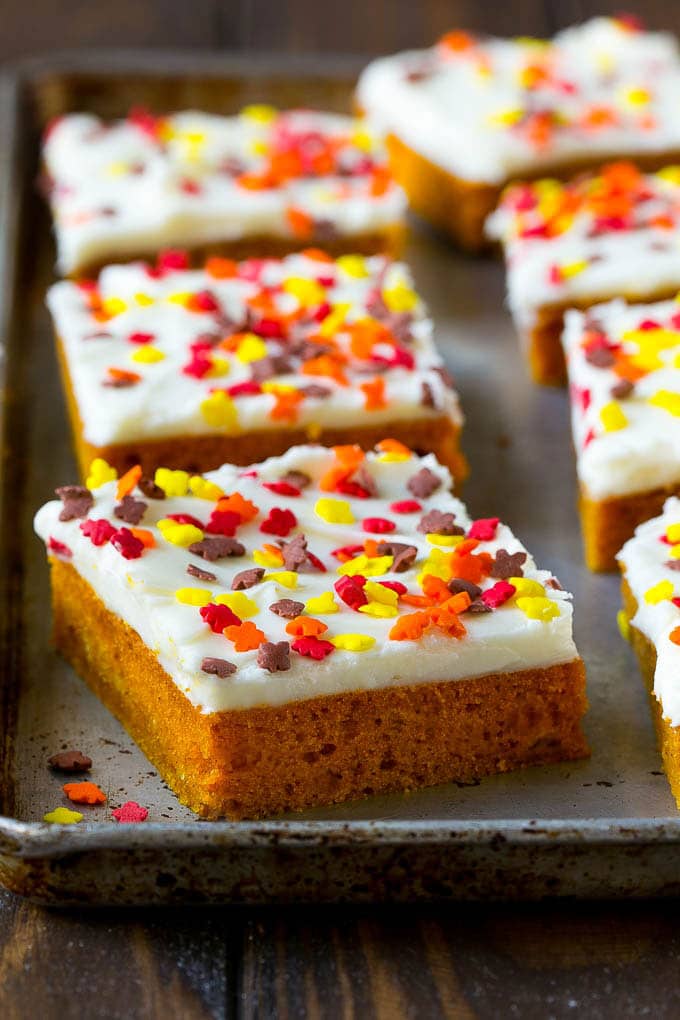Pumpkin Bars Recipe | Pumpkin Cake | Pumpkin Dessert #pumpkin #fall #dessert #bajap #thanksgiving A baking sheet of frosted pumpkin bars.