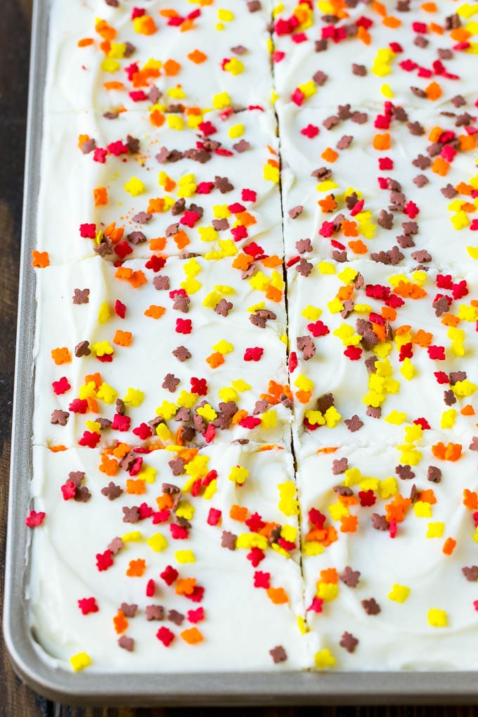 Pumpkin Bars Recipe | Pumpkin Cake | Pumpkin Dessert #pumpkin #fall #dessert #bajap #thanksgiving Cream cheese frosting and sprinkles spread over cake.