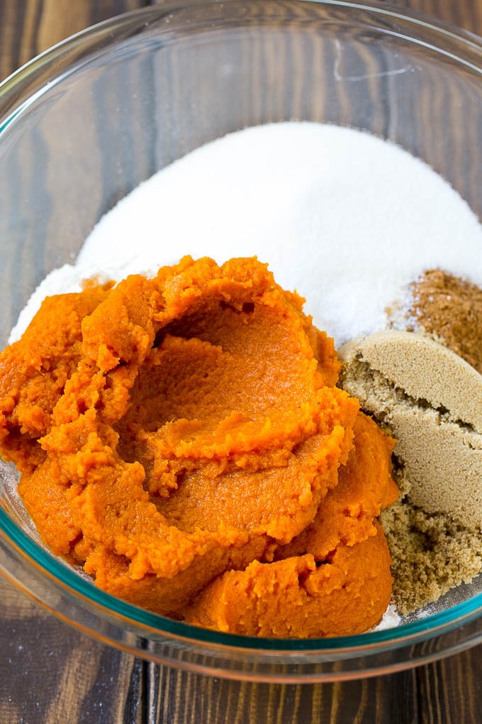 Pumpkin Bars Recipe | Pumpkin Cake | Pumpkin Dessert #pumpkin #fall #dessert #bajap #thanksgiving Pumpkin puree, brown sugar and flour in a bowl.