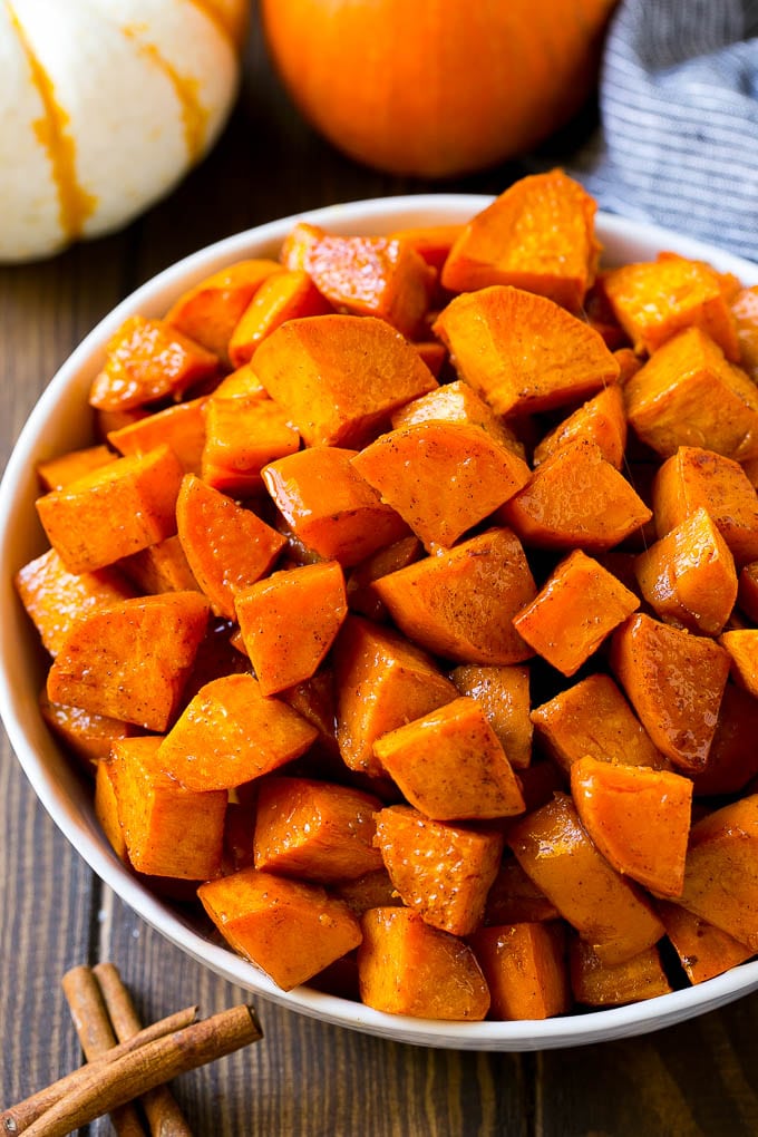 Maple Roasted Sweet Potatoes Recipe | Easy Sweet Potatoes | Baked Sweet Potatoes | Sweet Potato Side Dish #sweetpotatoes #cinnamon #maple #butter #fall #sidedish #dinner #bajap A bowl of maple roasted sweet potatoes with cinnamon and butter on top.