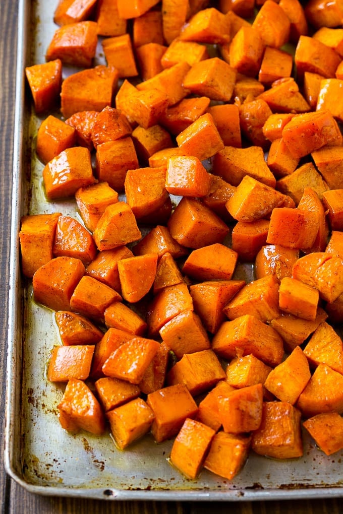 Maple Roasted Sweet Potatoes Recipe | Easy Sweet Potatoes | Baked Sweet Potatoes | Sweet Potato Side Dish #sweetpotatoes #cinnamon #maple #butter #fall #sidedish #dinner #bajap A sheet pan of roasted sweet potatoes.