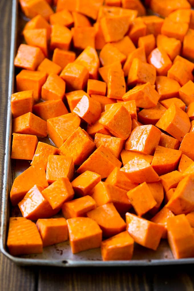 Maple Roasted Sweet Potatoes Recipe | Easy Sweet Potatoes | Baked Sweet Potatoes | Sweet Potato Side Dish #sweetpotatoes #cinnamon #maple #butter #fall #sidedish #dinner #bajap Raw diced sweet potatoes on a sheet pan, ready to go into the oven.