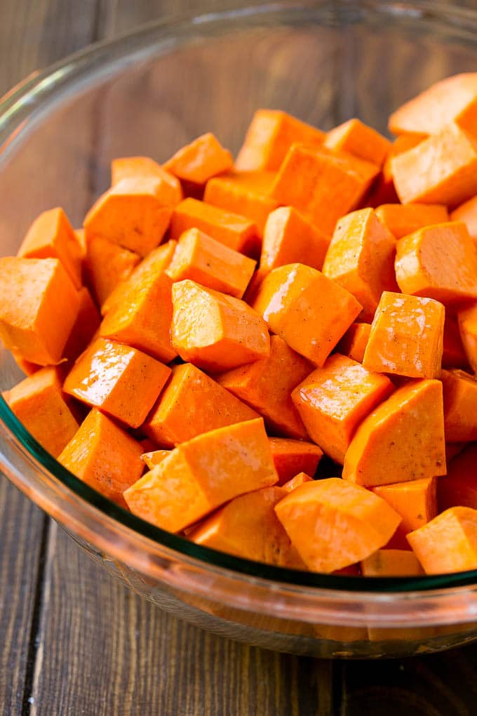 Maple Roasted Sweet Potatoes Recipe | Easy Sweet Potatoes | Baked Sweet Potatoes | Sweet Potato Side Dish #sweetpotatoes #cinnamon #maple #butter #fall #sidedish #dinner #bajap A bowl of peeled and diced yams.