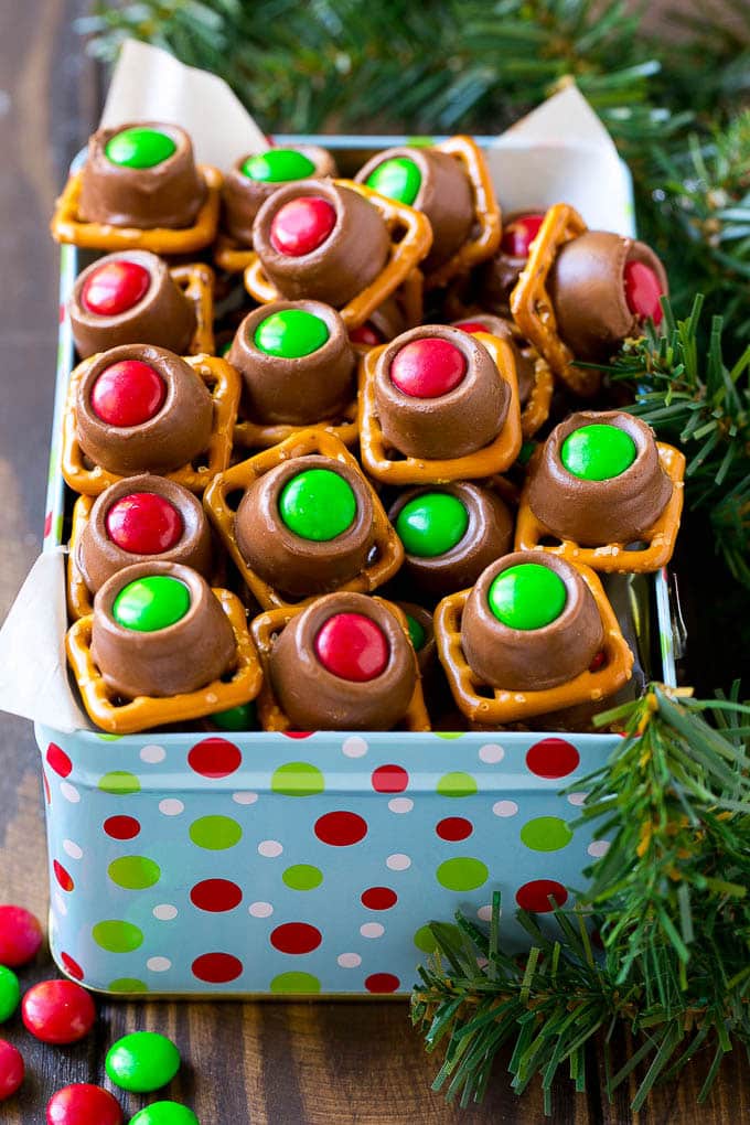 Rolo Pretzels Recipe | Chocolate Pretzels | Caramel Pretzels | Holiday Candy #christmas #baking #dessert #candy #chocolate #caramel #pretzels #bajap A gift tin full of Christmas colored Rolo pretzels.