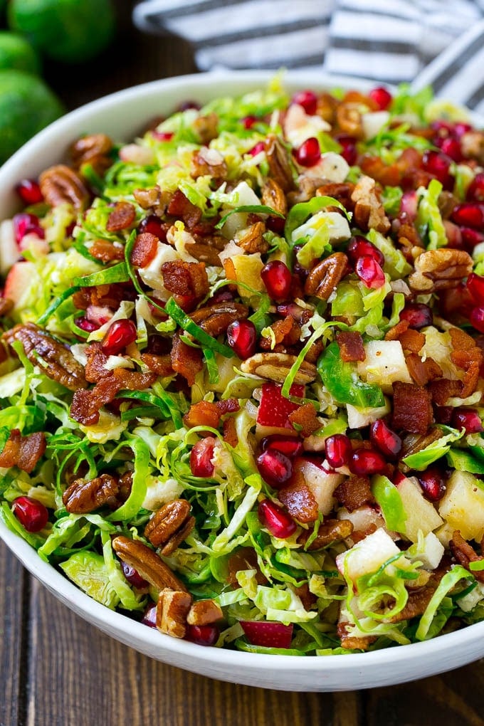 Brussels Sprout Salad Recipe | Shredded Brussels Sprouts Salad | Fall Salad #salad #brusselssprouts #bacon #thanksgiving #pomegranate #apple #dinner #bajap Brussels sprout salad with shredded brussels sprouts, pomegranate, pecans, feta cheese, apples and bacon.