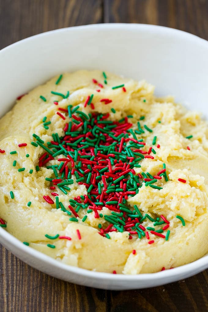 Cake Mix Cookies Recipe | Sprinkle Cookies | Christmas Cookies #cookies #christmas #sprinkles #dessert #baking #bajap A bowl of dough with sprinkles on top.