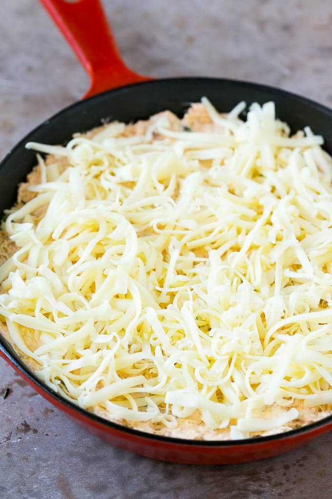 Crab Dip Recipe | Hot Crab Dip | Seafood Dip #dip #crab #seafood #appetizer #bajap #cheese Shredded Monterey Jack cheese sprinkled over a skillet of mixture.