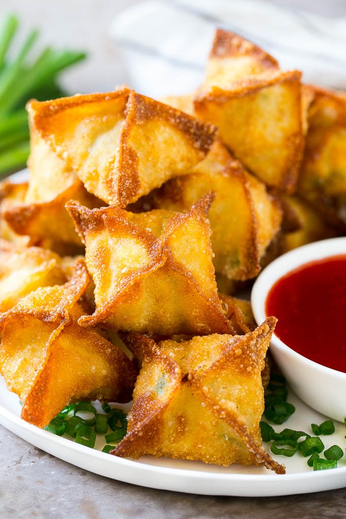 Crab Rangoon Recipe | Crab Wontons | Cream Cheese Wontons #crab #cheese #appetizer #snack #chinesefood #dinner #bajap A pile of crab rangoon wontons filled with a creamy crab mixture.