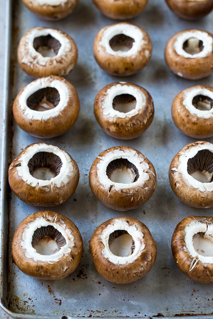 Crab Stuffed Mushrooms Recipe | Stuffed Mushrooms | Mushroom Appetizer #crab #seafood #mushrooms #lowcarb #appetizer #bajap Cremini mushroom caps on a sheet pan.