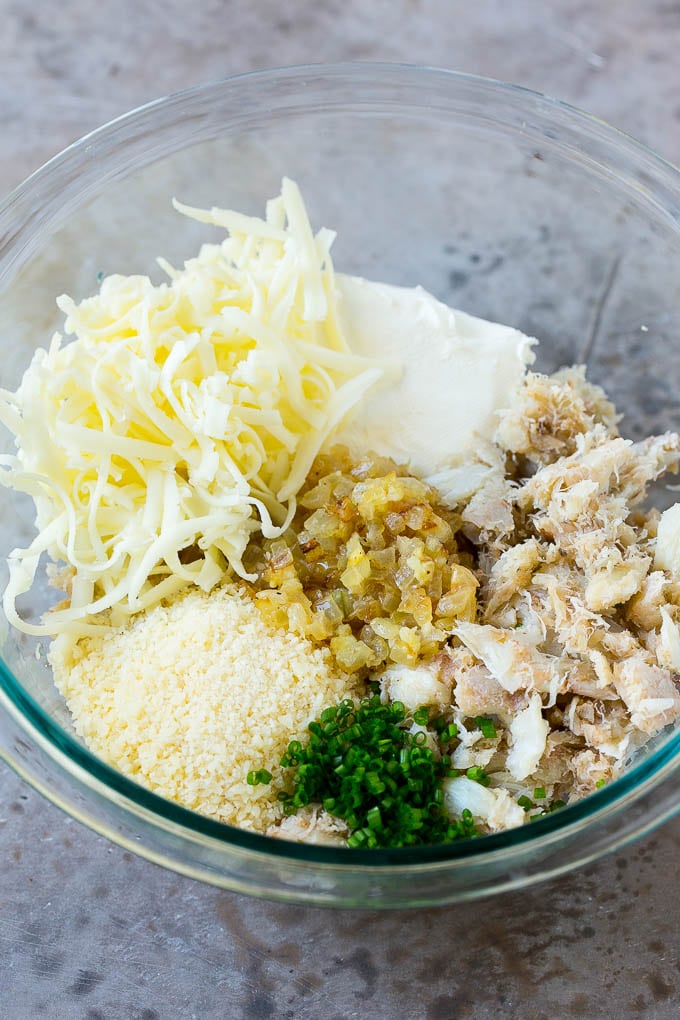 Crab Stuffed Mushrooms Recipe | Stuffed Mushrooms | Mushroom Appetizer #crab #seafood #mushrooms #lowcarb #appetizer #bajap A bowl of crab meat, cheese, chives, onions and garlic.