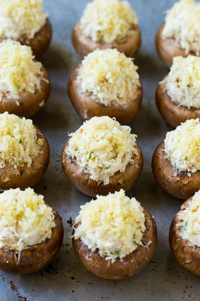 Crab Stuffed Mushrooms Recipe | Stuffed Mushrooms | Mushroom Appetizer #crab #seafood #mushrooms #lowcarb #appetizer #bajap Uncooked crab stuffed mushrooms on a sheet pan.