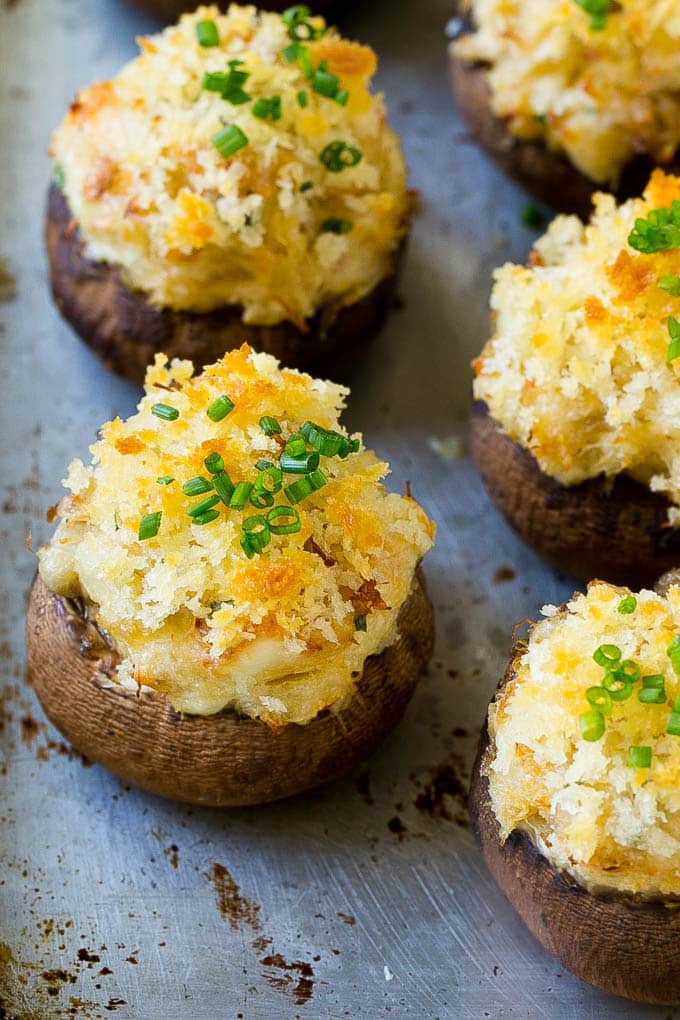 Crab Stuffed Mushrooms Recipe | Stuffed Mushrooms | Mushroom Appetizer #crab #seafood #mushrooms #lowcarb #appetizer #bajap Crab stuffed mushrooms on a sheet pan topped with sliced chives.