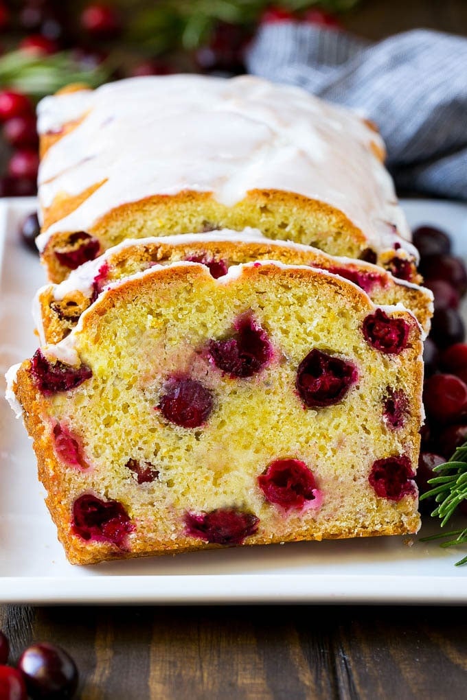 Cranberry Bread Recipe | Cranberry Loaf | Cranberry Orange Bread #cranberry #bread #baking #dessert #fall #bajap Sliced cranberry bread on a serving plate.