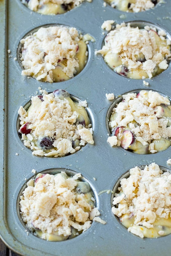 Cranberry Muffins Recipe | Cranberry Orange Muffins #cranberry #muffins #orange #fall #dessert #bajap Muffins topped with streusel ready to go into the oven.
