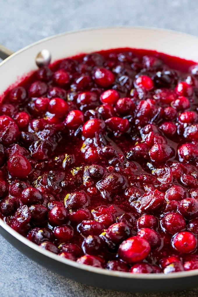 Cranberry Orange Sauce Recipe | Homemade Cranberry Sauce | Fresh Cranberry Sauce #cranberry #orange #fall #thanksgiving #sauce #dinner #bajap Cranberry orange sauce simmering in a skillet.