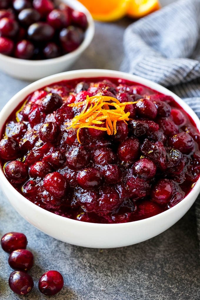 Cranberry Orange Sauce Recipe | Homemade Cranberry Sauce | Fresh Cranberry Sauce #cranberry #orange #fall #thanksgiving #sauce #dinner #bajap A bowl of cranberry orange sauce topped with fresh orange zest.