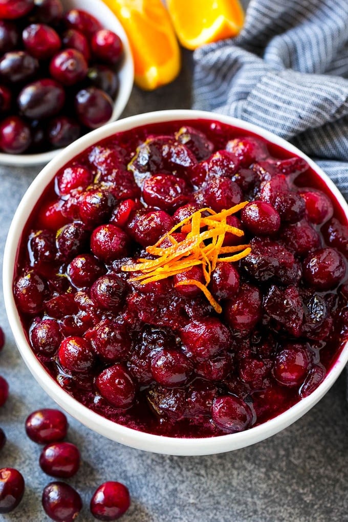 Cranberry Orange Sauce Recipe | Homemade Cranberry Sauce | Fresh Cranberry Sauce #cranberry #orange #fall #thanksgiving #sauce #dinner #bajap Cranberry orange sauce, topped with fresh orange zest in a serving bowl.