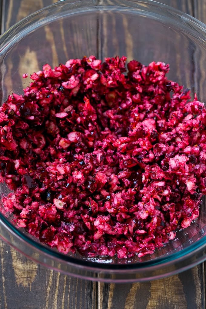 Cranberry Salad Recipe | Fluff Salad #cranberry #salad #fall #dinner #bajap #thanksgiving Chopped cranberries mixed with sugar in a bowl.