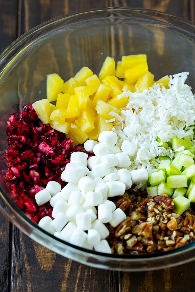 Cranberry Salad Recipe | Fluff Salad #cranberry #salad #fall #dinner #bajap #thanksgiving Chopped cranberries, apples, pineapple, marshmallows, pecans and coconut in a mixing bowl.