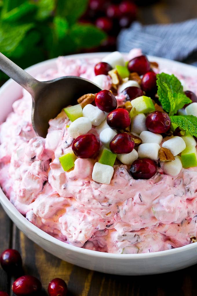 Cranberry Salad Recipe | Fluff Salad #cranberry #salad #fall #dinner #bajap #thanksgiving Cranberry salad with a serving spoon in it.
