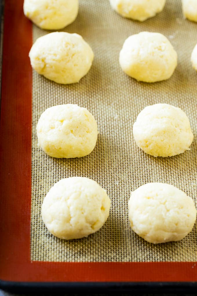 Gooey Butter Cookies Recipe | Cake Mix Cookies | Sprinkle Cookies | Christmas Cookies #cookies #butter #sprinkles #christmas #dessert #baking #bajap Balls of dough on a baking sheet.