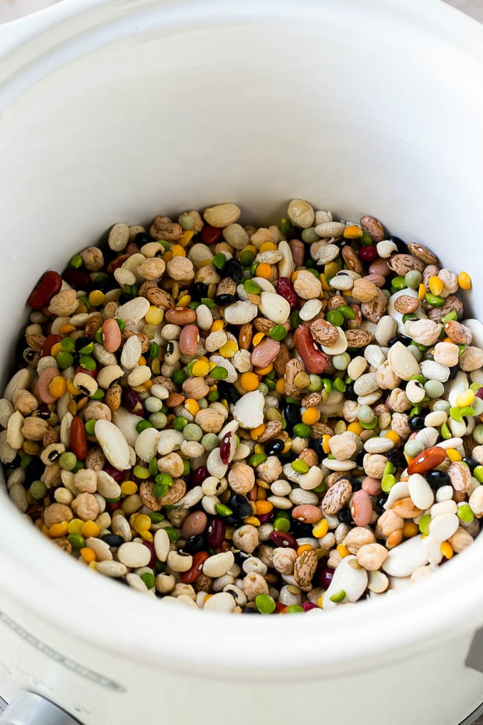 Ham and Bean Soup Recipe | Slow Cooker Ham and Bean Soup | Crockpot Ham and Bean Soup | Leftover Ham Recipe #ham #beans #soup #slowcooker #crockpot #dinner #bajap A mixture of dried beans in a crock pot.