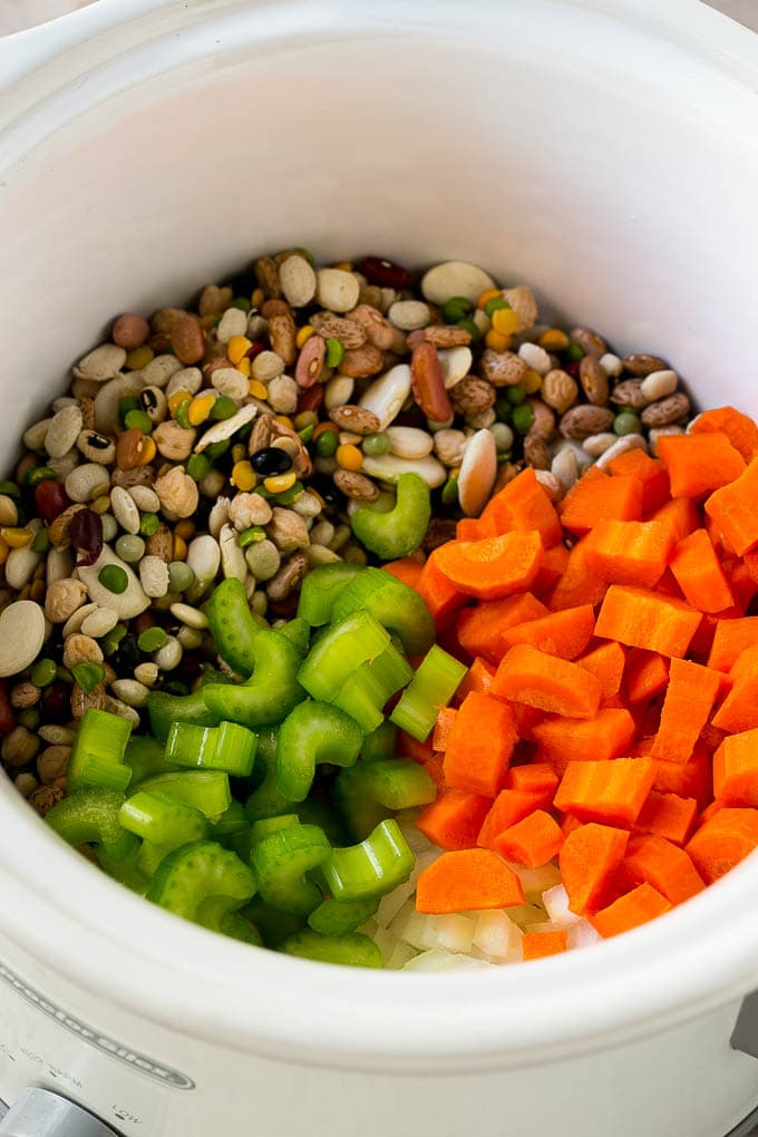 Ham and Bean Soup Recipe | Slow Cooker Ham and Bean Soup | Crockpot Ham and Bean Soup | Leftover Ham Recipe #ham #beans #soup #slowcooker #crockpot #dinner #bajap Dried beans, carrots, onions and celery in the slow cooker.