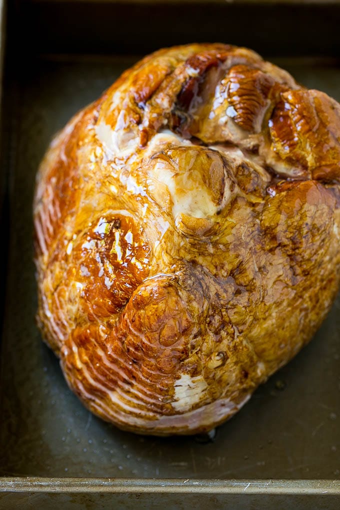 Honey Baked Ham Recipe | Glazed Ham | Holiday Ham #ham #dinner #bajap #christmas #thanksgiving #easter A honey coated ham, face down, in a baking dish.
