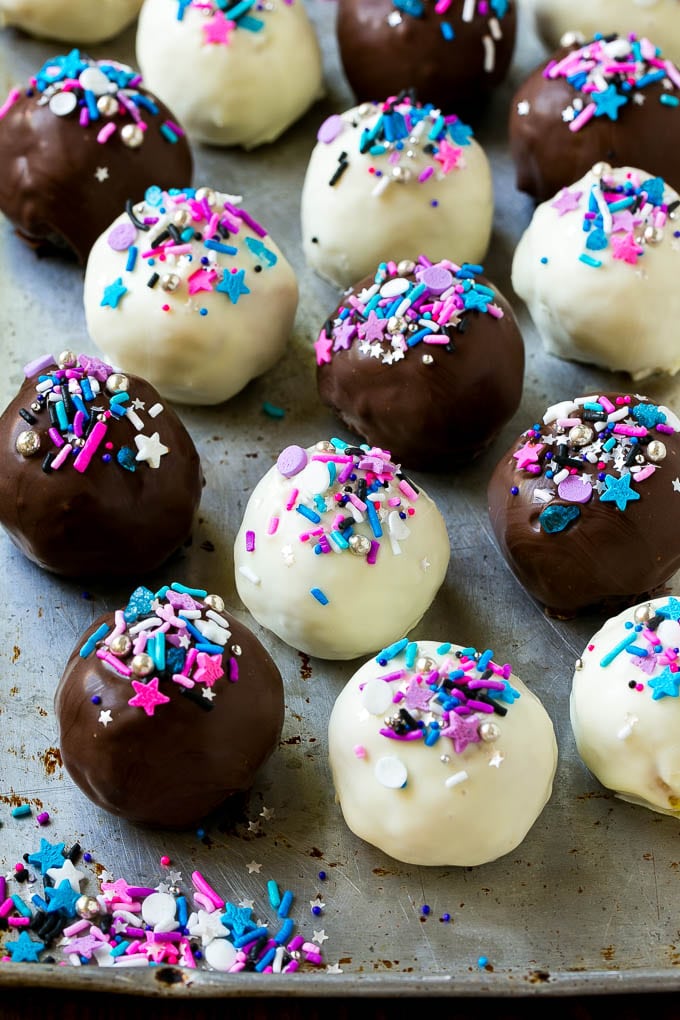 Oreo Balls Recipe | Oreo Truffles | Homemade Candy #truffles #candy #oreos #chocolate #sprinkles #dessert #christmas #bajap Assorted colors of Oreo balls on a sheet pan.