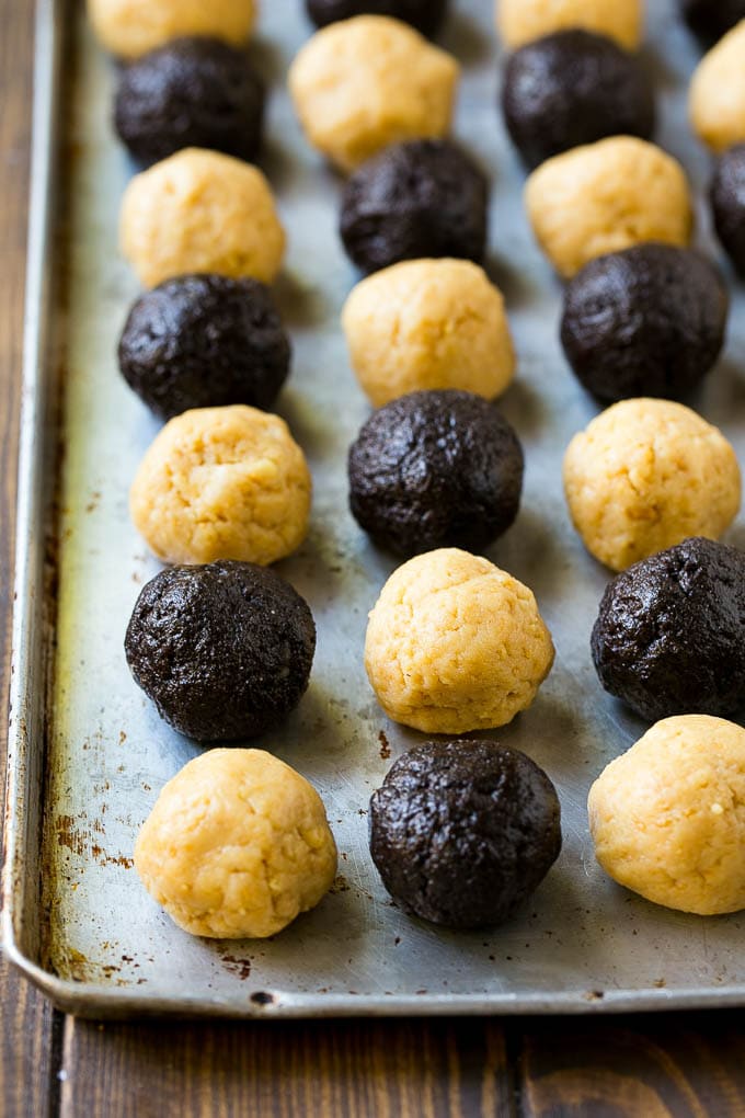 Oreo Balls Recipe | Oreo Truffles | Homemade Candy #truffles #candy #oreos #chocolate #sprinkles #dessert #christmas #bajap Oreo ball centers made from vanilla and chocolate Oreos on a sheet pan.