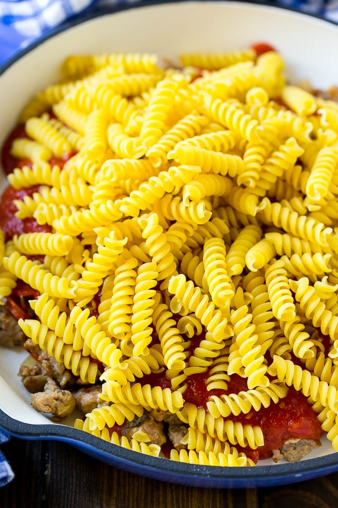 Pizza Pasta Recipe | Pepperoni Pasta | Sausage Pasta #italian #pepperoni #sausage #pizza #pasta #dinner #bajap #onepot Pepperoni, sausage, tomato sauce and uncooked pasta in a skillet.