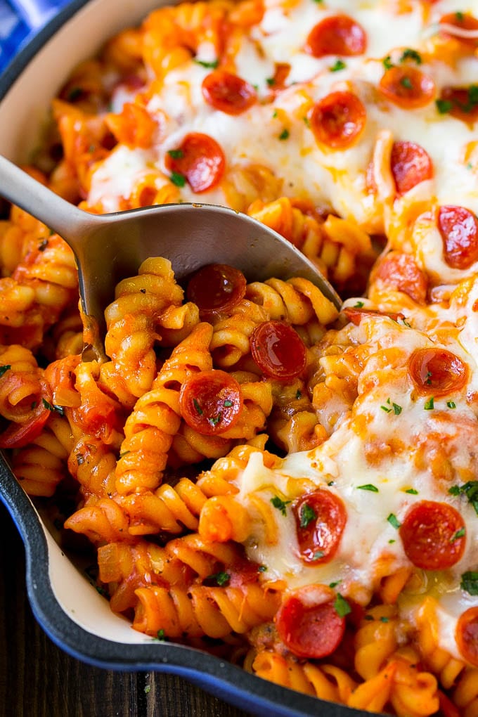 Pizza Pasta Recipe | Pepperoni Pasta | Sausage Pasta #italian #pepperoni #sausage #pizza #pasta #dinner #bajap #onepot A pan of pizza pasta with a serving spoon in it.