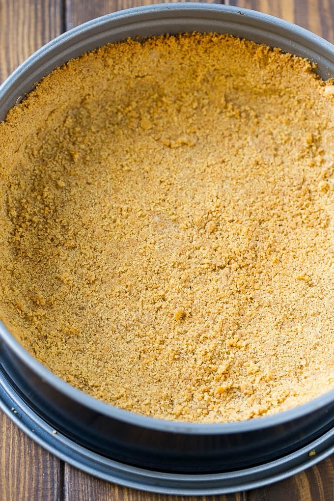 Pumpkin Cheesecake Recipe | Pumpkin Pie Cheesecake | Pumpkin Dessert #pumpkin #thanksgiving #dessert #cheesecake #fall #bajap A graham cracker crust pressed inside a springform pan.