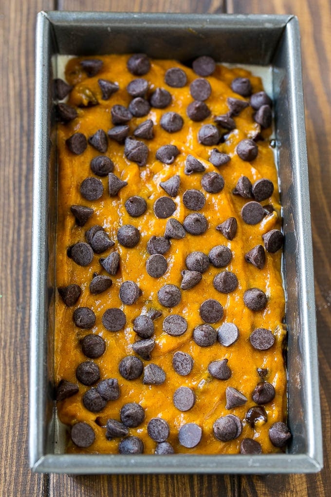 Pumpkin Chocolate Chip Bread Recipe | Pumpkin Bread | Chocolate Pumpkin Bread #pumpkin #bread #fall #chocolate #baking #dessert #bajap A loaf pan of pumpkin chocolate chip bread batter.