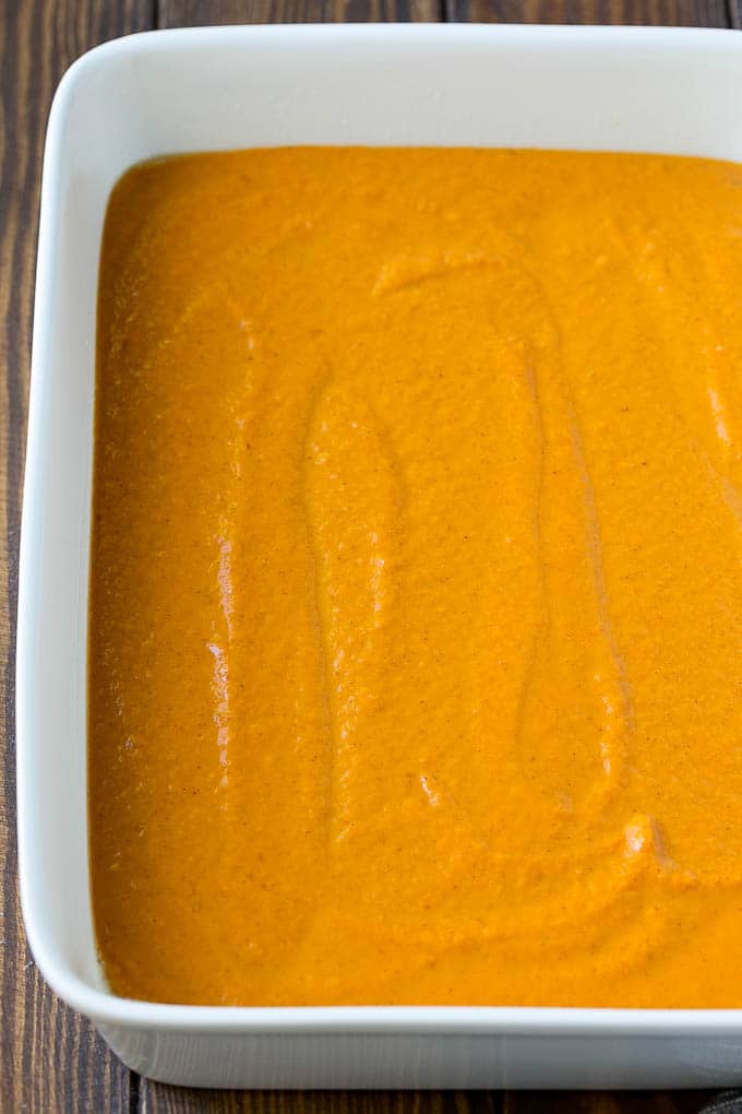 Pumpkin Dump Cake Recipe | Pumpkin Cake | Pumpkin Pie Cake #pumpkin #cake #pecans #fall #thanksgiving #dessert #bajap Pumpkin pie filling poured into a baking dish.