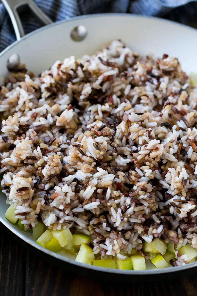 Wild Rice Pilaf Recipe | Thanksgiving Side Dish | Rice Pilaf #rice #apple #cranberry #fall #glutenfree #thanksgiving #bajap WIld rice, onions and apples in a skillet.