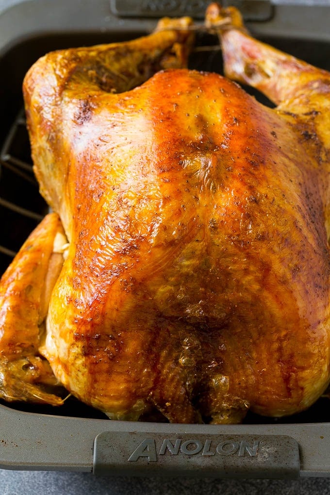 Roast Turkey Recipe | Thanksgiving Turkey | Holiday Turkey | Baked Turkey #turkey #thanksgiving #christmas #dinner #glutenfree #bajap A roasted turkey in a baking pan.