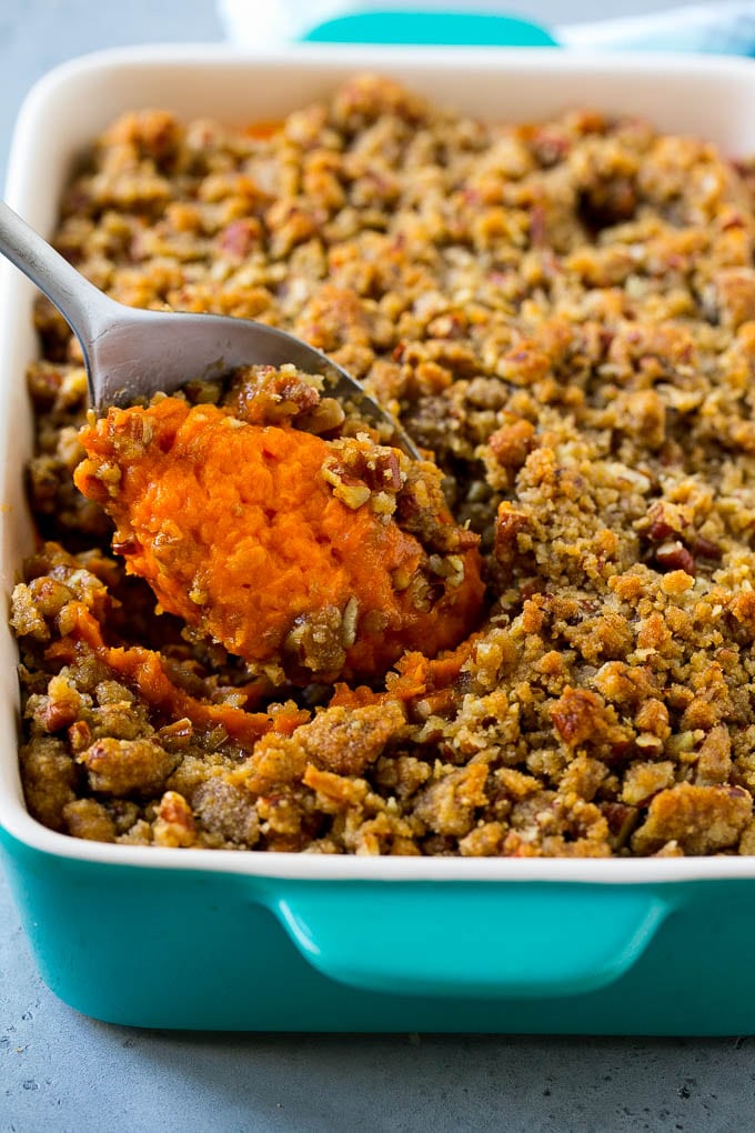 Ruth's Chris Sweet Potato Casserole Recipe | Sweet Potato Casserole | Mashed Sweet Potatoes #sweetpotatoes #casserole #thanksgiving #christmas #holidays #dinner #bajap #sidedish Ruth's Chris sweet potato casserole with a serving spoon in it.