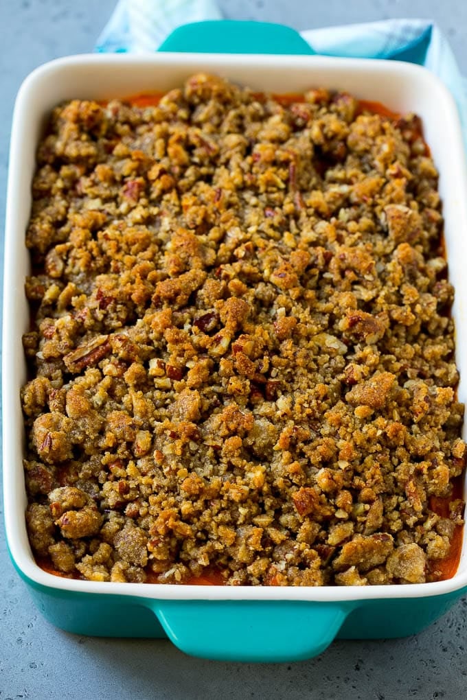 Ruth's Chris Sweet Potato Casserole Recipe | Sweet Potato Casserole | Mashed Sweet Potatoes #sweetpotatoes #casserole #thanksgiving #christmas #holidays #dinner #bajap #sidedish A baking dish of Ruth's Chris sweet potato casserole topped with streusel.